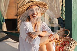 Laughing young girl in summer hat and swimwear