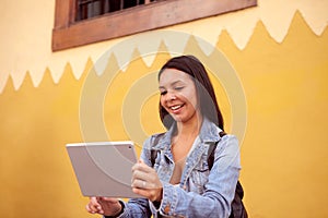 Laughing young girl with a tablet pc