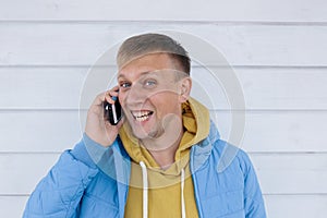 Laughing young man talking on the phone. man using smart phone