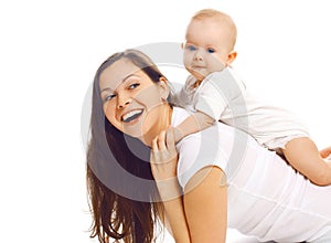 Laughing young mother playing with baby and having fun