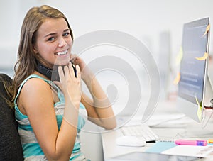 Laughing young student working in the computer room