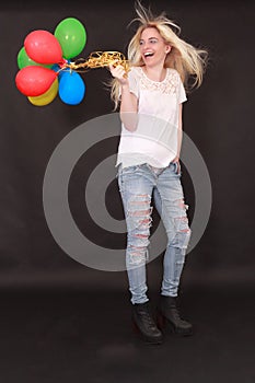 Laughing young woman with aerial balloons in the hand