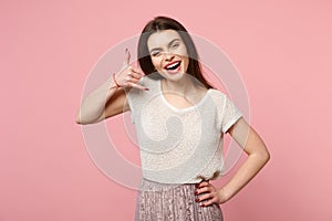 Laughing young woman in casual light clothes posing isolated on pastel pink wall background, studio portrait. People