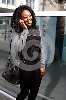 Laughing young woman chatting on a mobile