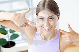 Laughing young woman with implanted teeth closeup