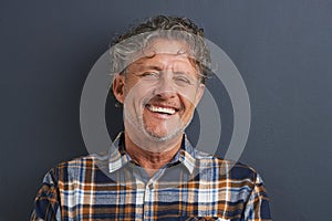 Laughter is the language of the soul. A cropped portrait of a handsome mature man laughing.