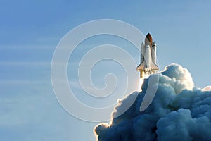 The launch of the space shuttle against the background of the sky and smoke. Elements of this image furnished by NASA photo