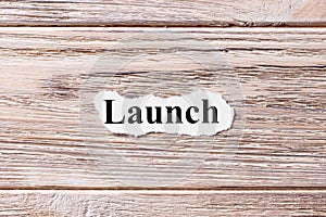 LAUNCH of the word on paper. concept. Words of LAUNCH on a wooden background