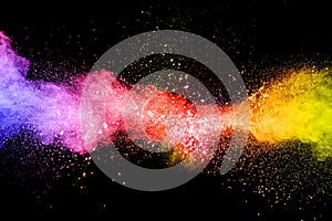 Launched colorful powder on black background.Color powder explosion.Colorful dust splashing