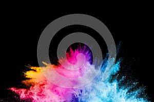 Launched colorful powder on black background.Color powder explosion.Colorful dust splashing