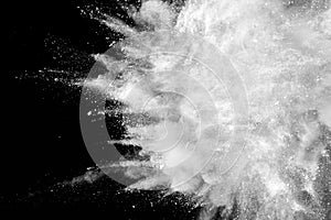 Launched white powder splash on black background.