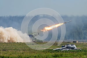 Launching military rockets in the woodlands, war shot defense attack.