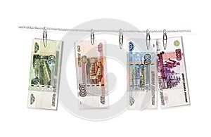 Laundering of money. Gray incomes. The banknotes of the 1997 Bank of Russia hang on paper clips. Isolated on white background 3d