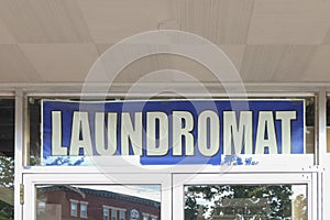 Laundromat sign in a transom window