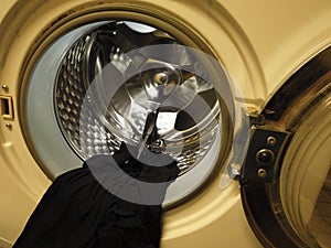 Laundromate with open door and cloth hanging out from the drum