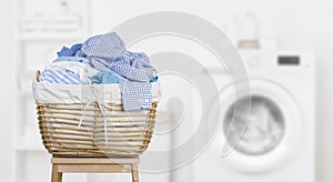 Laundry basket on blurred background of modern washing machine