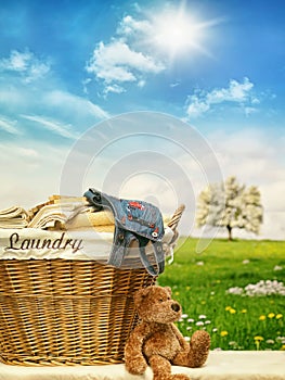 Laundry basket with clothes against a blue sky