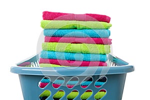 Laundry basket filled with colorful folded towels