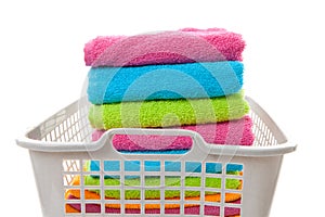 Laundry basket filled with colorful folded towels