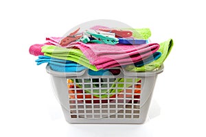 Laundry basket filled with towels and pegs