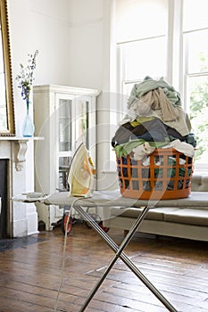 Laundry Basket And Iron On Ironing Board
