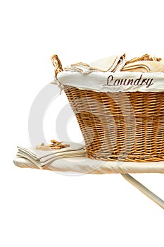 Laundry basket on ironing board against white