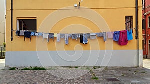 Laundry day in Venice, Italy, clothes hanging from building to dry