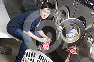 Laundry Day Woman Folds Infant Clothes Laundromat