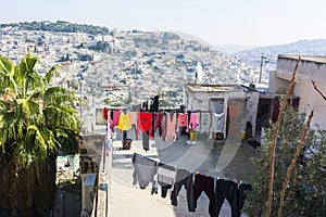 Laundry dries outdoor on a roof of house, located outside of Jerusalem Old City Walls. Panoramic city view. Israel.