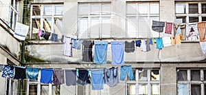 Laundry dryings on the rope. Washed clothes drying outside of an old house. Washed clothes drying. Fresh clean clothes