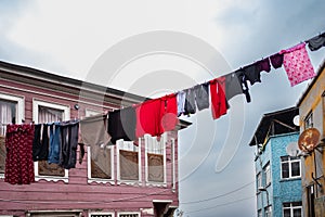 Laundry hanging on a clothes line in old city. Washing hanging on clothes lines. Drying clothes hanging outside