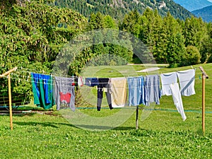 Laundry hanging on clothesline outdoor in the green nature