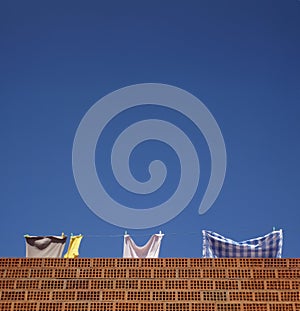 Laundry hanging out to dry in the sun on a clear day with a blue sky