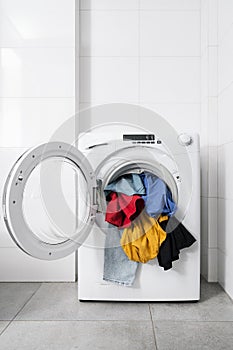 Dirty clothes in open washing machine indoors