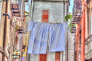 Laundry line with bed sheets in Bosa old town, Sardinia