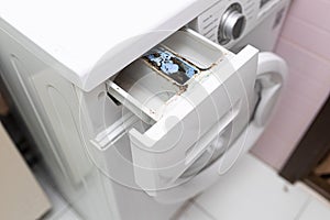 Laundry machine dispenser compartment for soap and powder detergent and conditioner with corrosion, rust. Tech hygiene