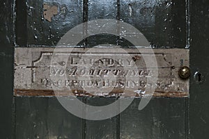 Laundry No Admittance Sign on Old Green Wooden Door