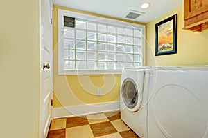 Laundry room with glass block window
