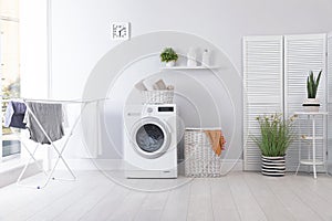 Laundry room interior with washing machine