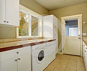 Laundry room with tile counters and sink.