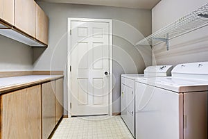Laundry room with washer and dryer with tile floor.