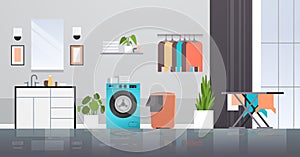 Laundry room with washing machine basket ironing board and clothes rack modern bathroom interior