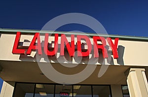 Laundry Sign on Building With Blue Sky