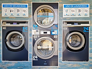 Laundry with washers and dryers without logos or brands, with instructions for use in Spanish and prices in euros