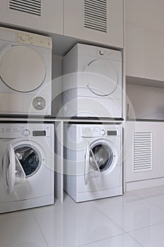 Laundry washing machine and dryer against  modern appliance household in laundry