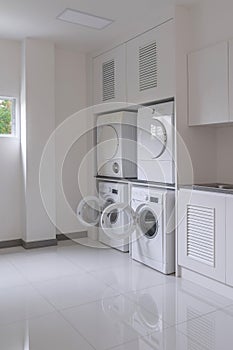 Laundry washing machine and dryer against modern appliance household in laundry room