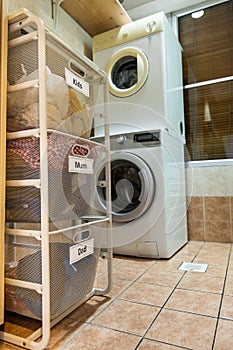 Laundry for washing sorted in group of kids, mum, dad in basket