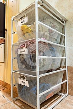 Laundry for washing sorted in group of kids, mum, dad in basket