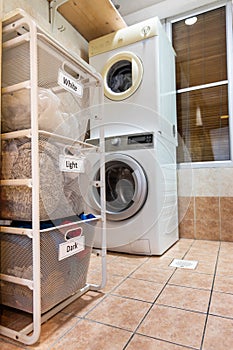 Laundry for washing sorted in group of white, light and dark in basket