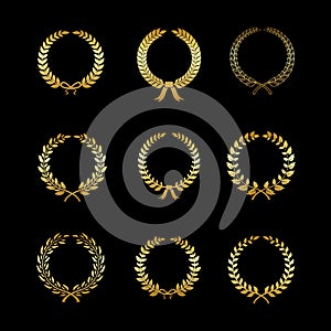 Laurels gold wreaths. Golden branches with leaf silhouette in circle form, foliate and wheat, oak and wreath. Heraldic photo